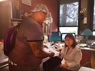 Dr. Esther Horrocks assists a student with his studies. (Photo by Hayley Jacobs)