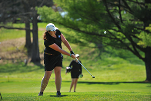 Sophomore Morgan Wirtz focuses on getting the ball on the green during the Mustangs spring invitational. (Photo by Sabina Moran)