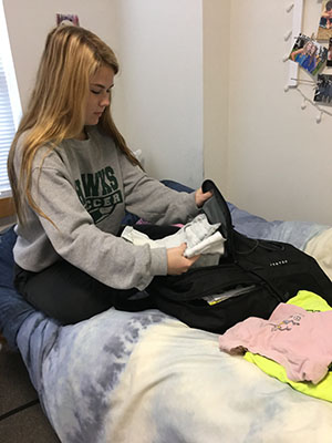 Freshman Carly Ensor begins packing clothes for her return home over fall break. (Photo by Sofia Sanchez)