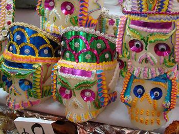 La Día de los Muertos is celebrated mostly in Mexican culture; one tradition is decorating sugar skulls with vivid icing, feathers and glitter.  (Photo from art-is-fun.com)