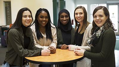 Samantha Roberts (left), Jocelyn Richards (second left), Gloria Collier (middle), Natalie Marrato (second right), and Michelle Crone (right) give back to the Owings Mills community through mentorship.  (Picture from stevenson.edu).