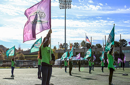 Members of the Stevenson University color guard practice with high school students at last years Stevenson University Band Day Experience. (Photo from Stevenson University Flickr)