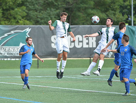 Sophomore Evan Joseph heads the ball to sophomore Dylan Holy in their game against Penn College. (Photo by Sabina Moran)