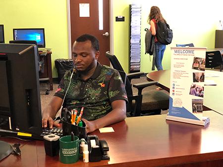 Mohamed Bah, senior student tech, working at Career Services located at Wooded Way. (photo by Wornden Ly) 