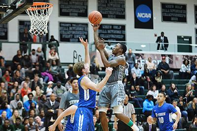 Senior Johnny Rhodes attempts to score in a home game against Elizabethtown College last season at Stevenson University Owings Mills Gym. (Photo by Sabina Moran)