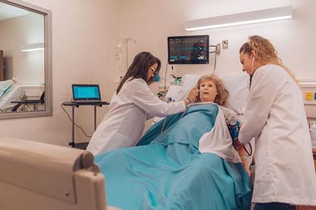 Nursing students recreate lifelike scenarios with a manikin in the simulation lab. (Photo from Hollis Caswell)
