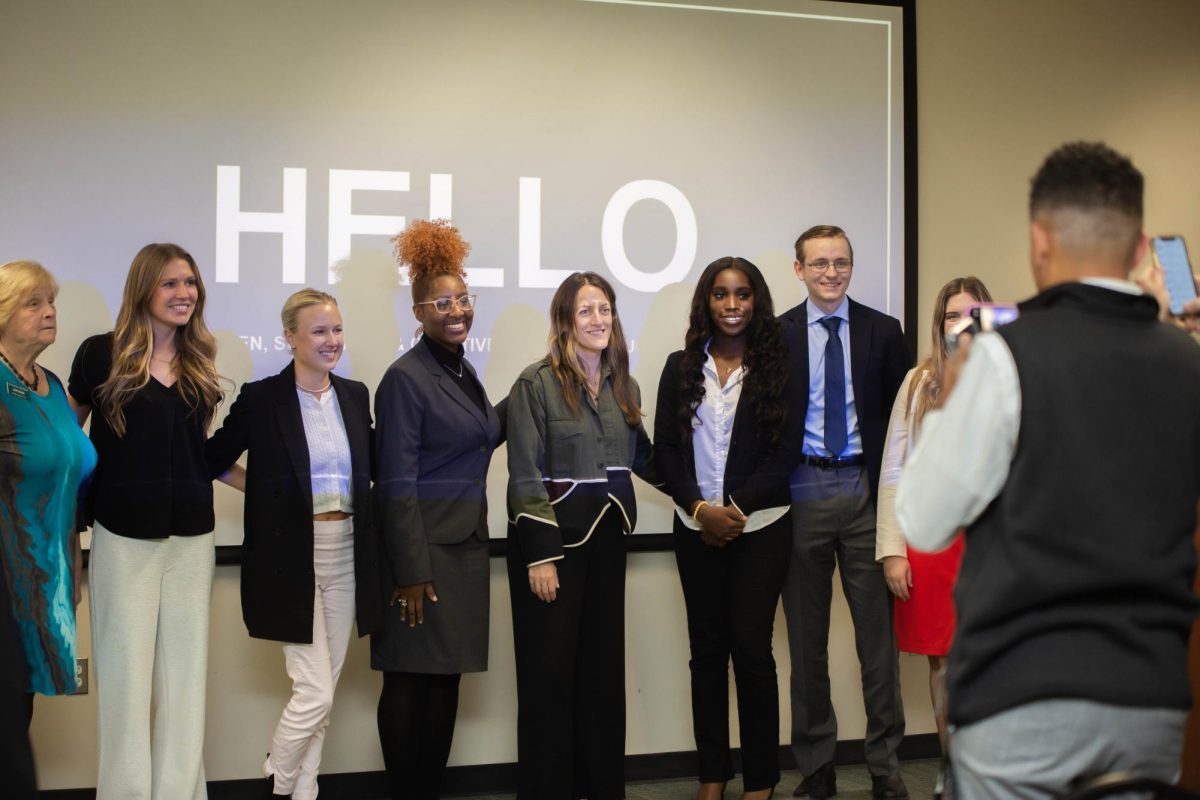 Communication Hub students, including host Grace-Frances Afful (to the right of Julie Allen), pose with the guest of honor.