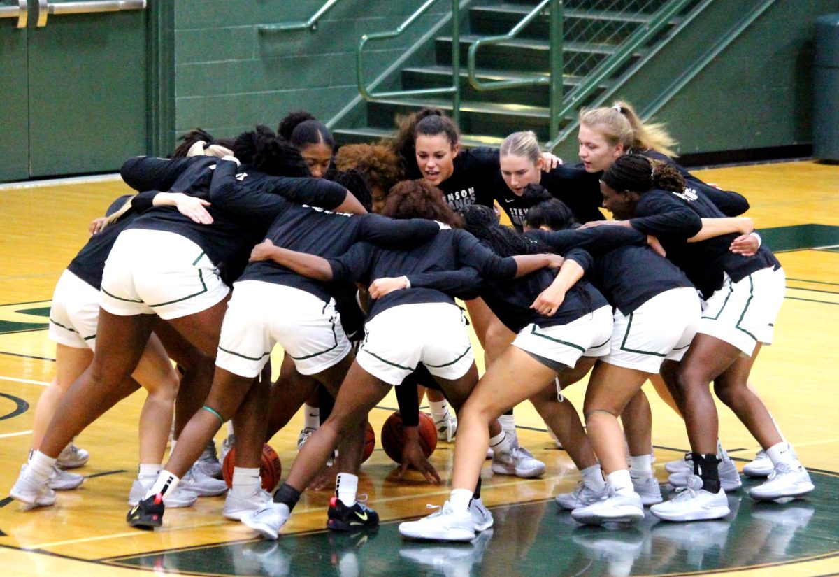 Womens basketball in a pre-game huddle.