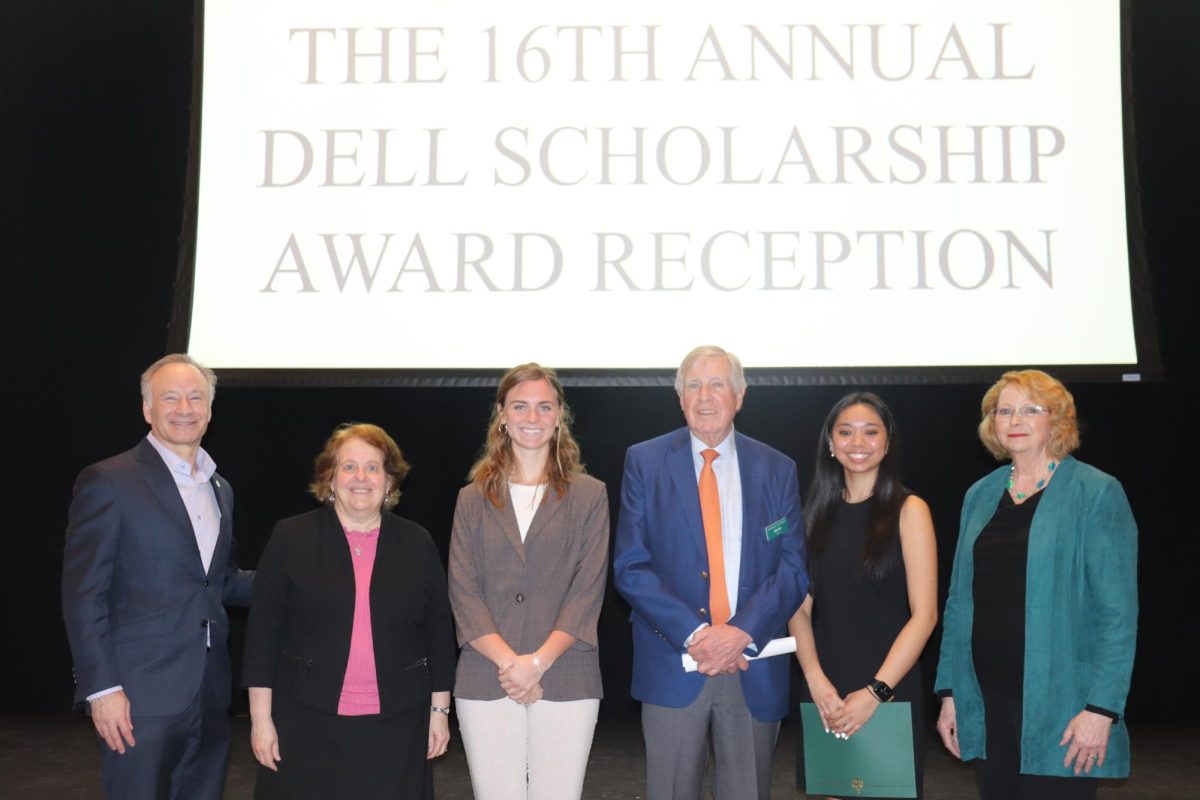 Dell Family Scholarship recipients smile alongside President Elliot Hirshman, Dean of the Brown School of Business and Leadership Sharon Buchbinder, and Mr. Sam M. Dell, III.
