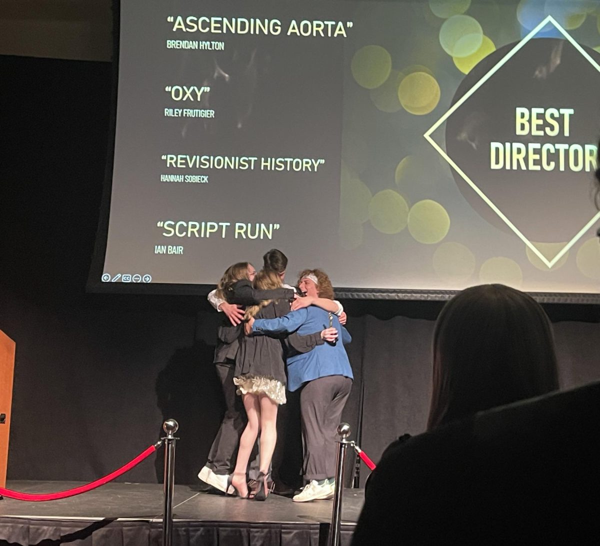 Best Director winner Hannah Sobieck and her crew Riley Frutiger, Ian Bair, Holt Hendershot, and Andres Johnson celebrate with a group hug after receiving their award