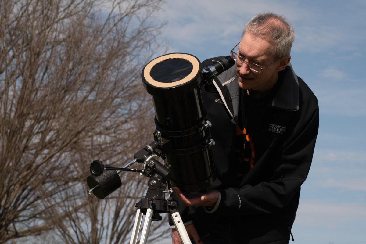 Professor of Physics Neal Miller spent the day huddled around the telescope, helping students get a closer look at the eclipse