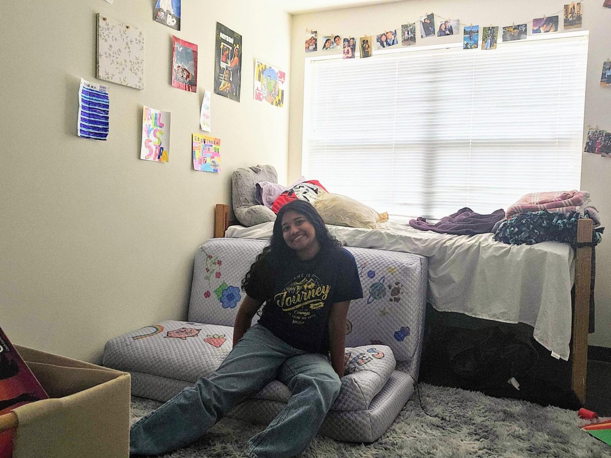 Second-year Alyssa Reddy shows off her stylish, foldable couch in her bright, decorative room.