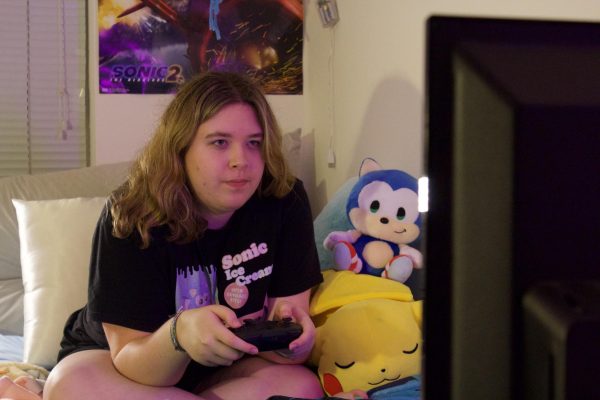 Second-year Erin McRoy locks in to play her video game with the support from her fandom representatives: Sonic the Hedgehog and Pikachu