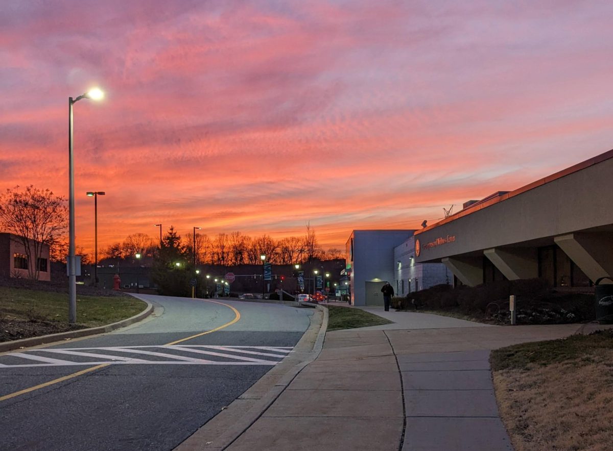 A vibrant sunset over the Caves Sports and Wellness Center