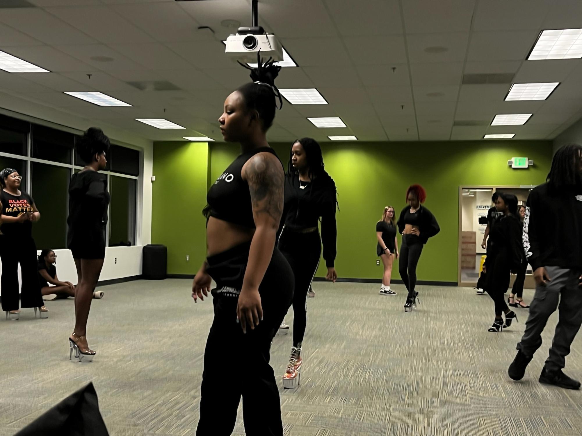 Allure Models members practice posture and balance.