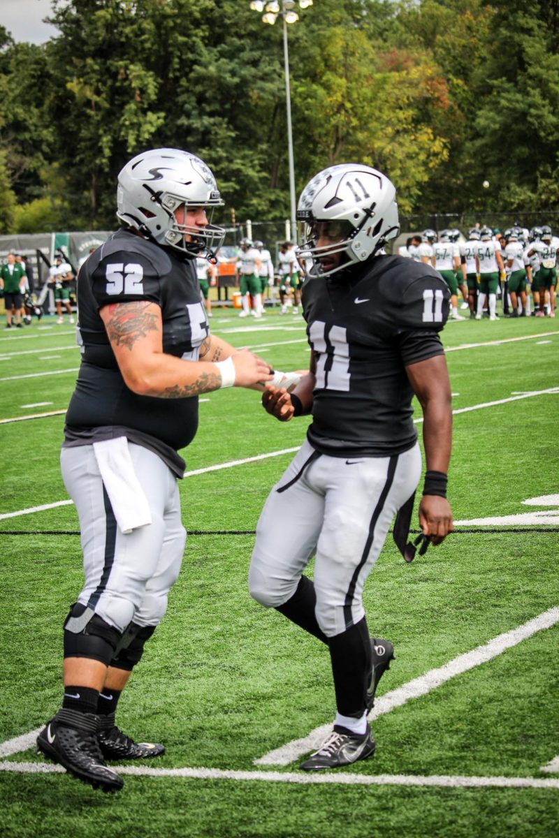 Jordan Adams celebrates with his teammates after throwing his first touchdown pass of the game