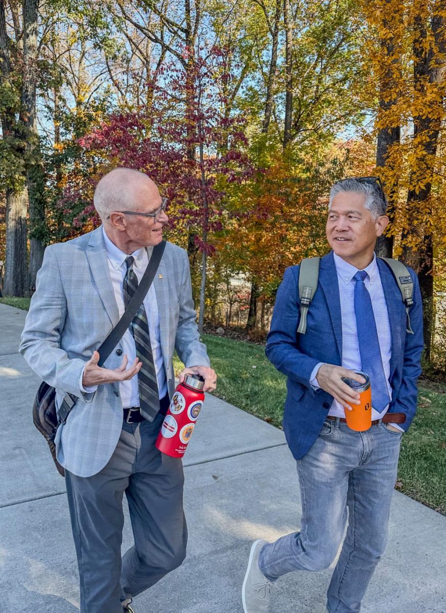 Senior Lecturer Jeff Browne (left) walks with Baltimore Banner reporter Hugo Kugiya (right) along the path between North and South campuses. Kugiya spoke to a Stevenson University audience Thursday on the value of human creativity in the age of artificial intelligence during the 16th annual Shapiro-Rouse Lecture in Garrison Hall North's Claire Moore Room.