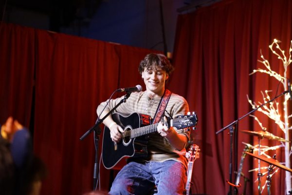 Jake Minch smiling as he sings a line in one of his unreleased songs.