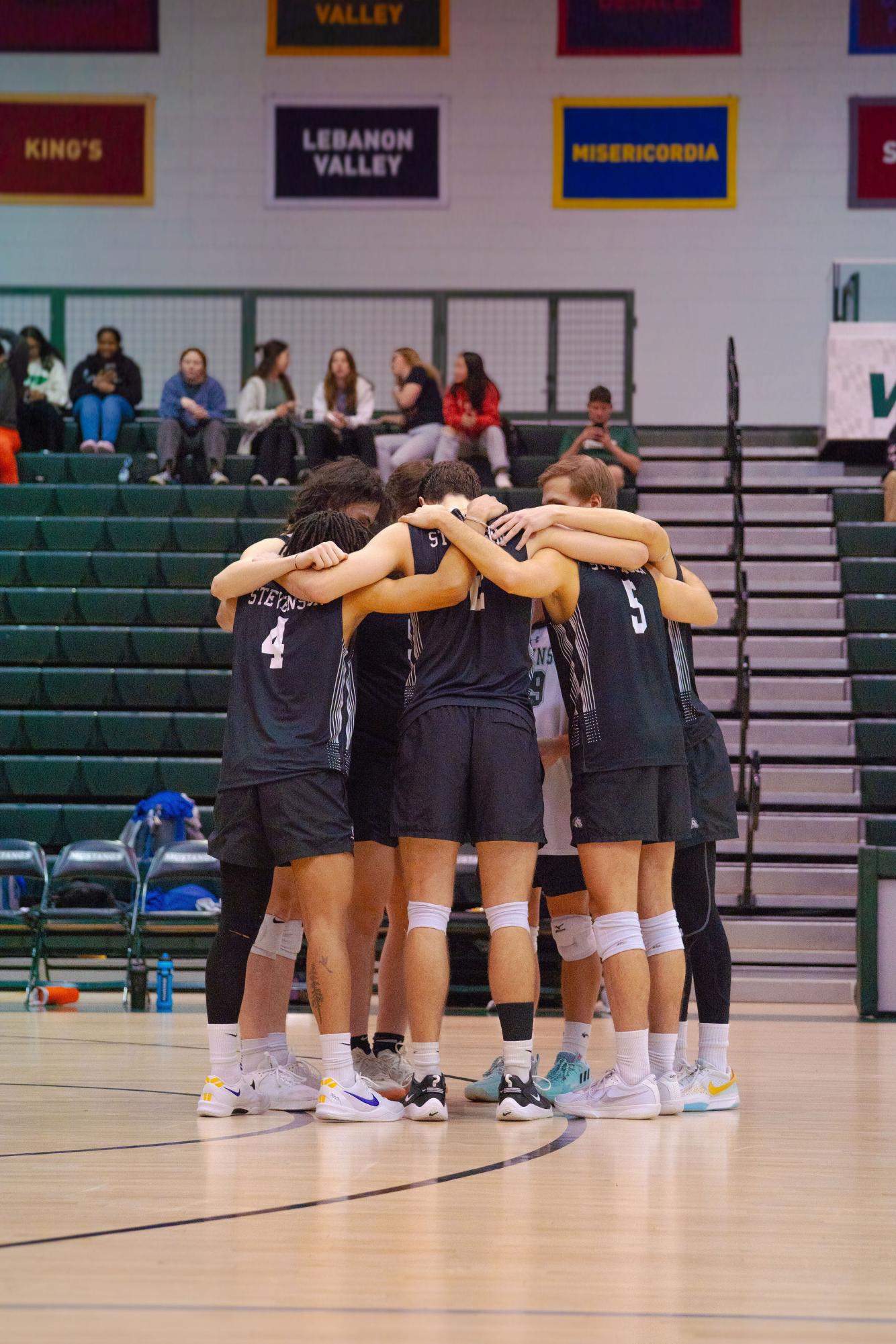 Stevenson Men's Volleyball huddles during a match 