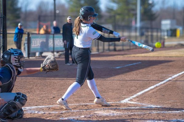 Tessa Boswell (No. 11) hits a ball and gets a single in a matchup earlier this season.