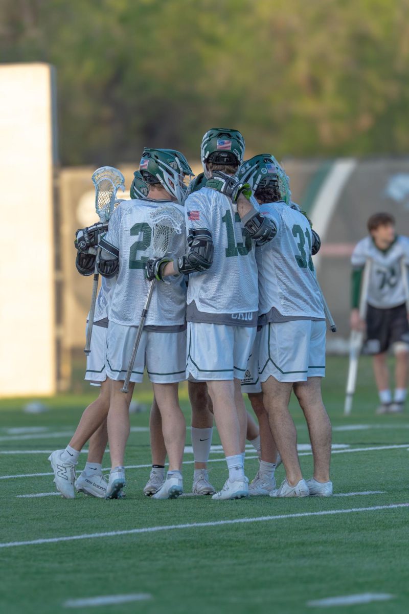 Men's lacrosse huddles during their match against Albright