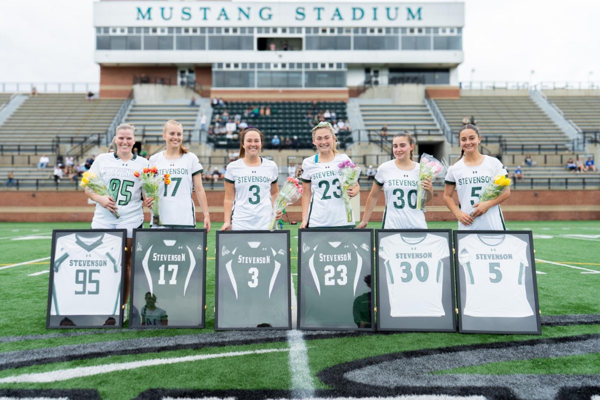 Women's Lacrosse seniors stand together prior to their senior day game.