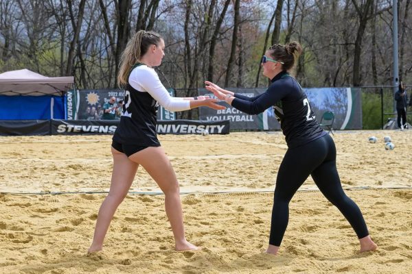 Claire Thompson (No. 23) & Scarlett Dunn (No. 22) high five each other during a previous match. 