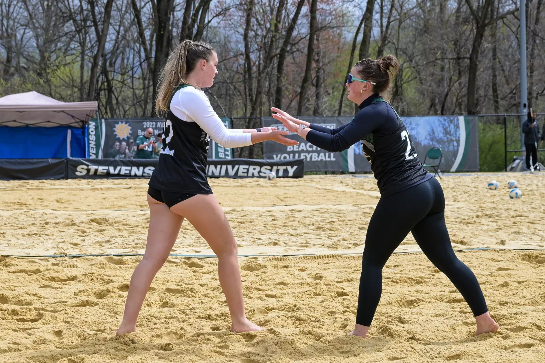 Claire Thompson (No. 23) & Scarlett Dunn (No. 22) high five each other during a previous match. 