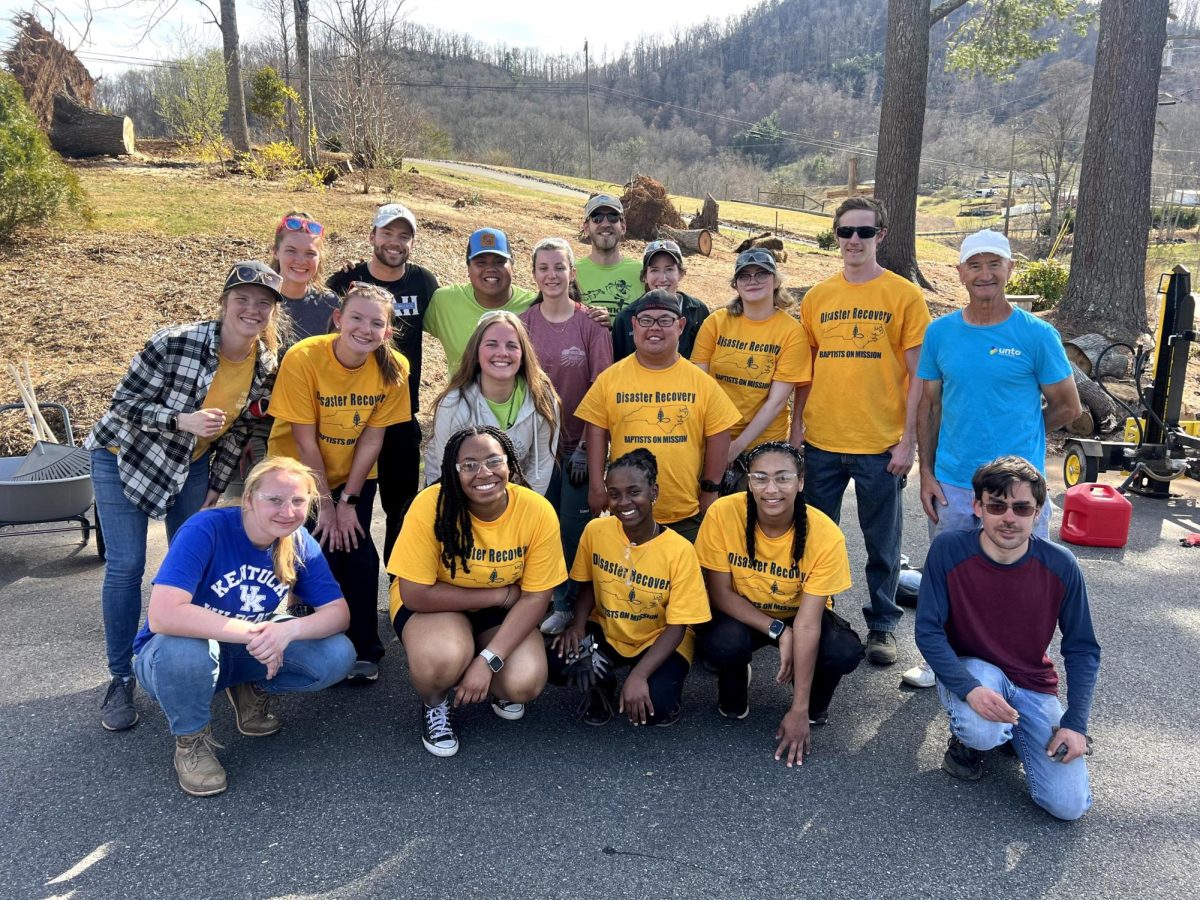A group of CRU students and UNTO volumeters after cleaning trees and debris from a local homeowner's property