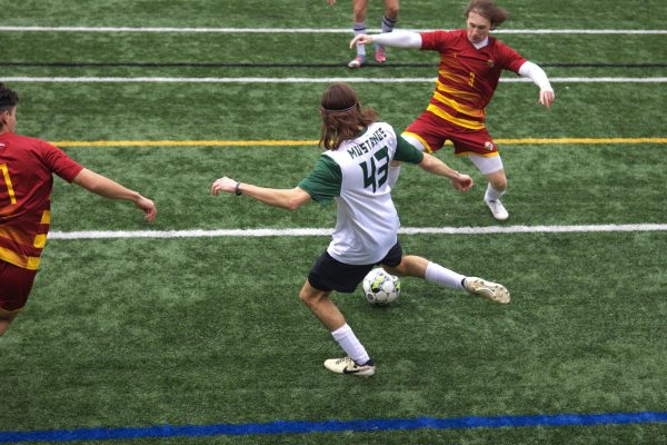 First-year defender Rocco Delgaudio passes the ball between Salisbury players.
