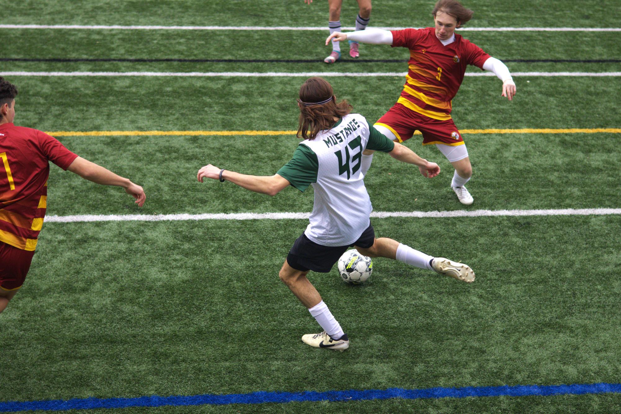 First-year defender Rocco Delgaudio passes the ball between Salisbury players.