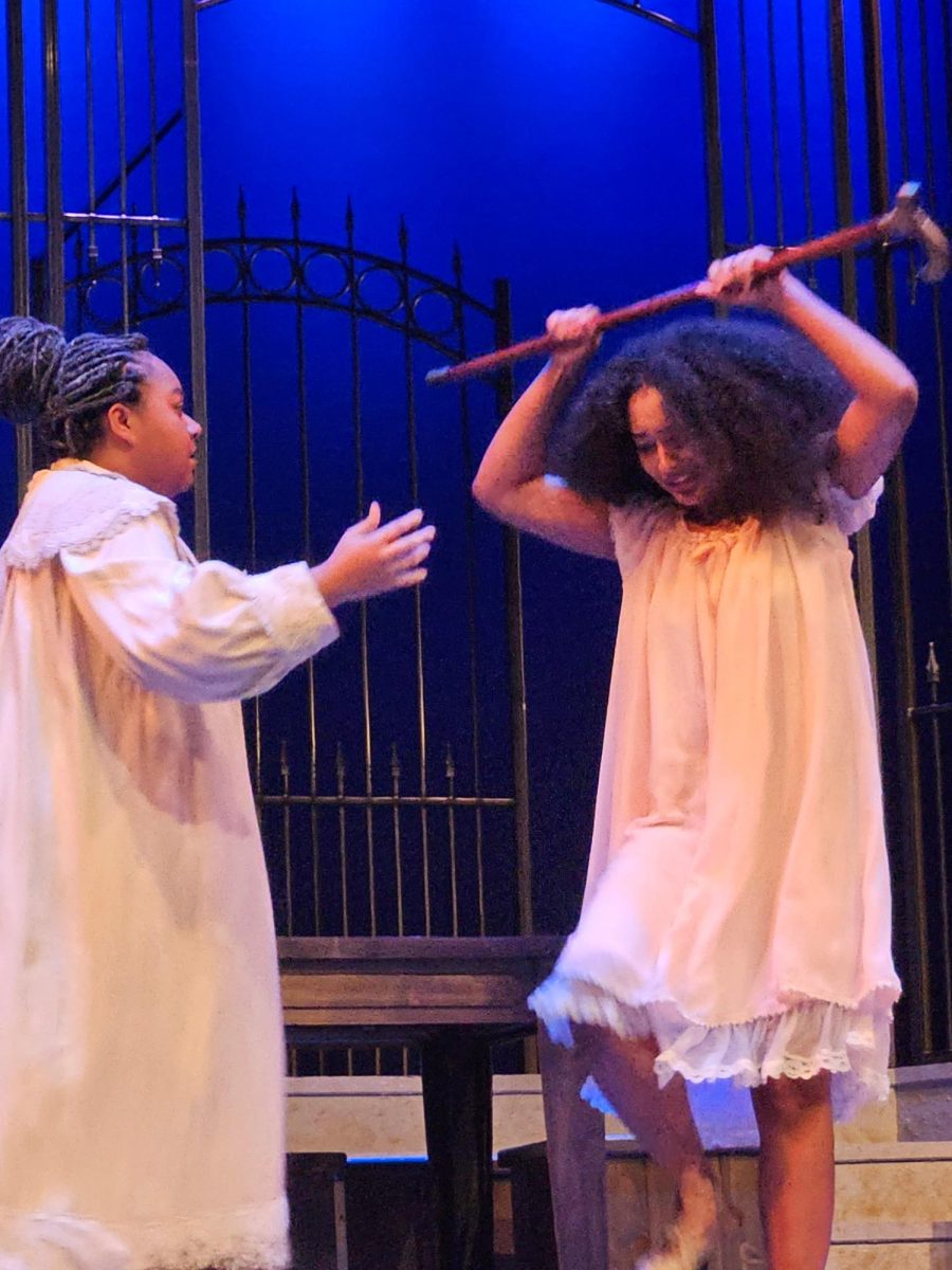 Adela (Renee Young, right) prepares to break Bernarda Alba's (Kyla Johnson, left) cane. 