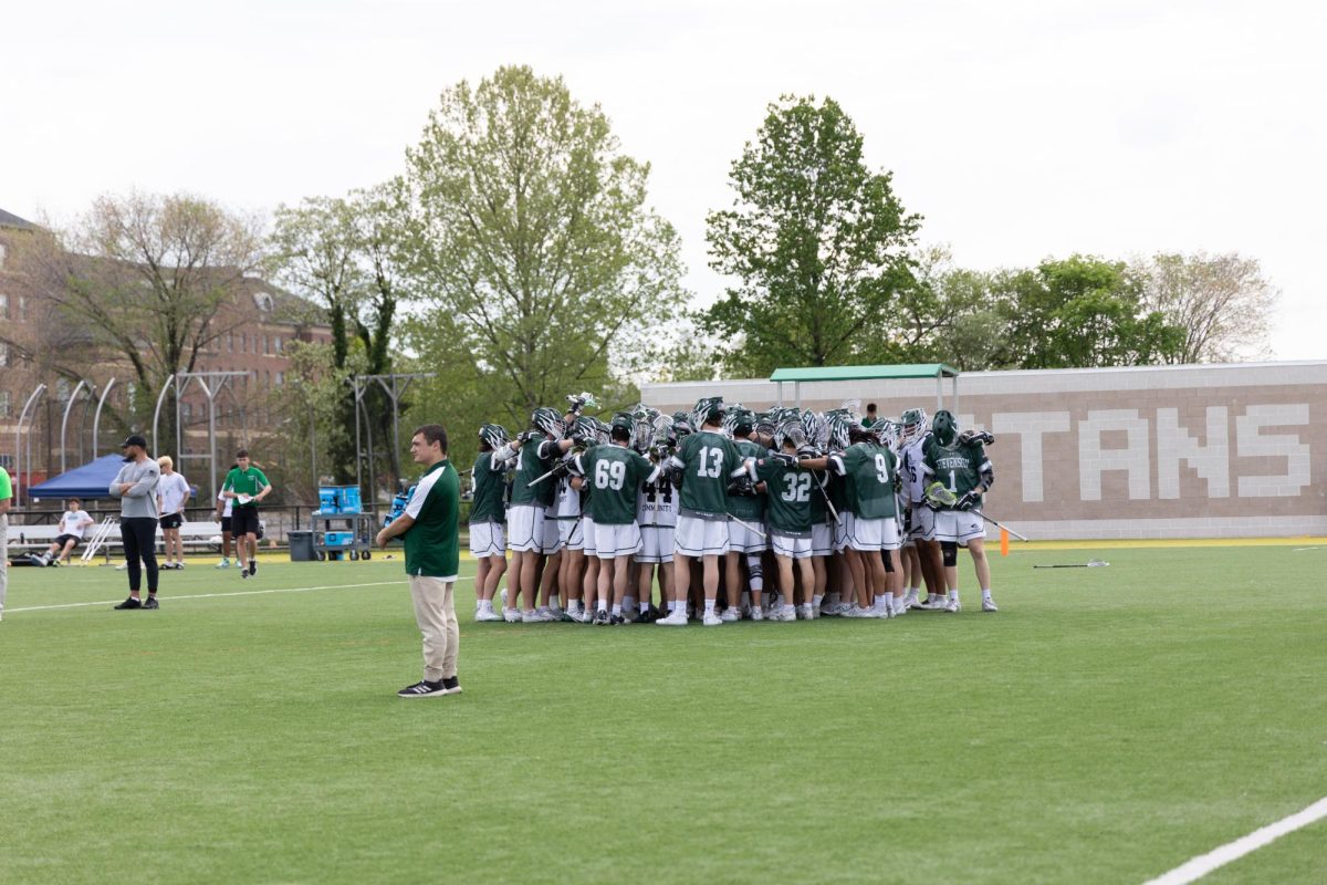 Men's lacrosse huddles prior to their MAC Championship game with the Spartans of York College