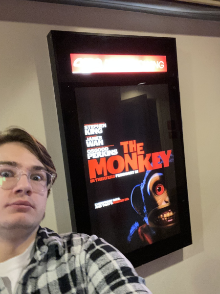 Reporter Ryan Lesh next to the poster for the film