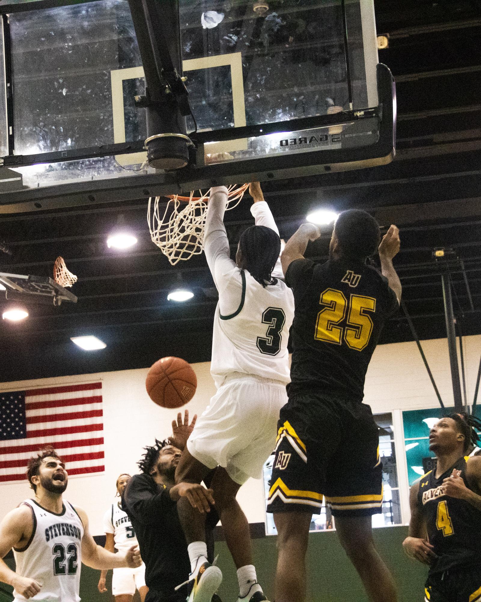David Pridgen (3) attacks the rim for a put-back dunk against Messiah in Stevenson's victory on Feb. 14 at Owings Mills Gym. Pridgen finished with 13 points and 9 rebounds.