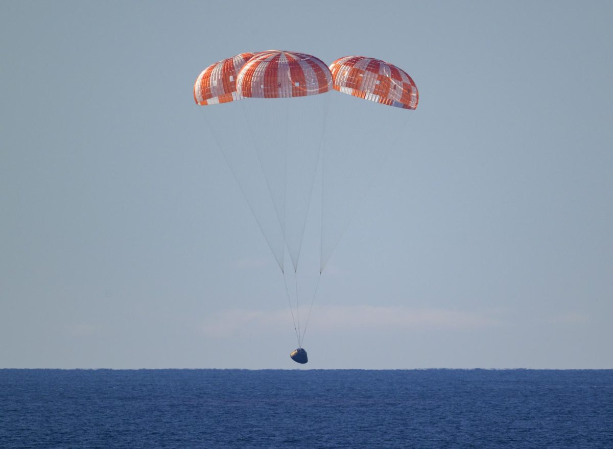 NASA’s Orion spacecraft with Artemis II crewmembers NASA astronauts Reid Wiseman, commander; Victor Glover, pilot; Christina Koch, mission specialist; and CSA (Canadian Space Agency) astronaut Jeremy Hansen, mission specialist aboard is seen under parachutes as it lands in the Pacific Ocean off the coast of California, Friday, April 10, 2026. NASA’s Artemis II mission took Wiseman, Glover, Koch, and Hansen on a 10-day journey around the Moon and back to Earth. Following a splashdown at 7:07 p.m. EDT, NASA, U.S. Navy, and U.S. Air Force teams are working to bring the crewmembers and Orion spacecraft aboard USS John P. Murtha.